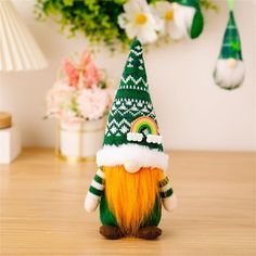 a green and yellow gnome figurine sitting on top of a wooden table