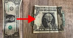 a dollar bill with an arrow pointing to it on top of a wooden table next to a hundred dollar bill