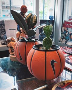 two basketball planters sitting on top of a table