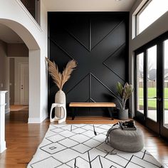 a living room filled with furniture and a large open floor plan in front of a black wall