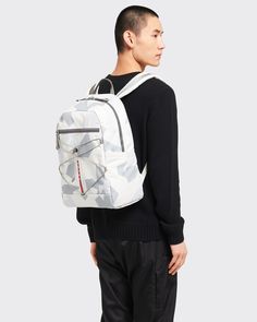 Mochila em tecido técnico estampado Cinza Marmoreado | PRADA Fabric Backpack, Prada Collection, White Backpack, Camouflage Print, Logo Label, Grey Prints, Sling Backpack, Mesh Fabric, Puffer Jacket