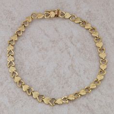 This ladies 14k yellow gold heart bracelet has alternating cut out, polished hearts and textured hearts. It measures 7.5" in length and 4.9mm in width. It also weighs 5.39 grams. It has a hidden box clasp and a figure eight safety catch. Condition: Pre-Owned *All items are thoroughly inspected for quality assurance purposes Gold Heart Cut Bracelets For Formal Occasions, Formal Gold Heart Cut Bracelets, Gold Heart Cut Bracelet For Formal Occasions, Valentine's Day Formal Yellow Gold Heart Bracelet, Yellow Gold Heart Bracelet For Valentine's Day, Formal Heart-shaped Yellow Gold Bracelet, Gold-toned Gold-plated Heart Bracelet As Gift, 14k Gold Heart Bracelet, Tarnish Resistant, Yellow Gold Heart-cut Bracelet With Heart Charm