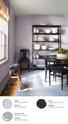 a dining room with purple walls and white dishes on the shelves in front of it