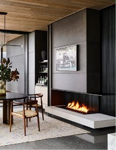 a dining room with a table and chairs next to a fire place in the fireplace