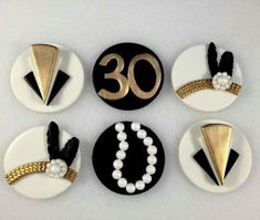 the number thirty five is decorated with black, white and gold buttons that are on top of each other