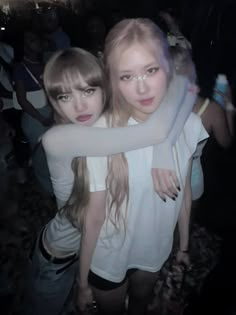 two girls hugging each other at a party