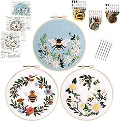 the embroidery kit includes two bees and three daisies, each with different designs