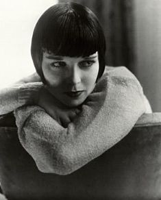 a black and white photo of a woman with short hair