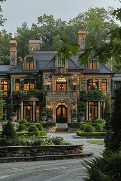 a large house with lots of windows and bushes