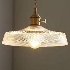 a light hanging from the ceiling in a room with gray walls and white trimmings