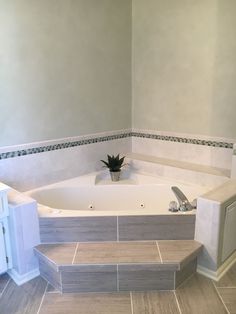 a bathroom with a jacuzzi tub and tiled floor