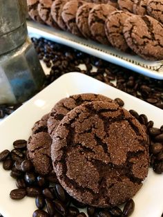 chocolate cookies and coffee beans on a white plate