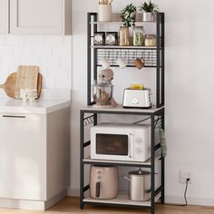 a kitchen area with a microwave, toaster and other items on a shelf in front of the counter