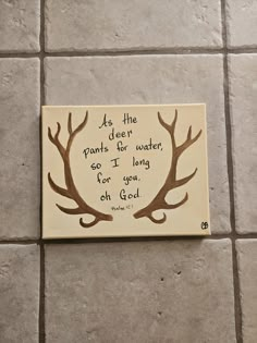 a piece of wood with an image of deer antlers and the words as the deer plants her water, so i long for you on god