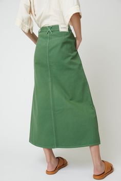 High waisted skirt, standard heavyweight cotton twill. - Relaxed fit- Fitted waist, Mid length skirt- Garment dyes with a front buttons made of recycled paper- Belt pulls on the waist- Two side pockets, one leg pocket, two back pockets Fabric Note Cotton 100%Machine wash gentle / Tumble dry low / No bleachWarm iron if neededDry clean optionalMade in U.S.A Green Mid Skirt, Tanna Midi Skirt, Mid Green Skirt, High Wasted Skirt, Wardrobe Building, Mid Length Skirt, Twill Skirt, Cotton Midi Skirt, Skirts Midi High Waisted