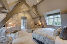 an attic bedroom with vaulted ceiling and white carpeted flooring is pictured in this image