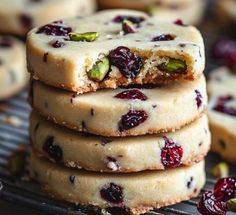 cranberry and pistachio shortbread cookies stacked on top of each other