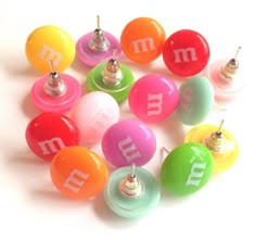 many different colored buttons with the letter m on them