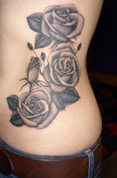 a woman's stomach with three roses on it