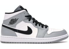 the air jordan 1 mid is available in grey and white, with black accents on the upper