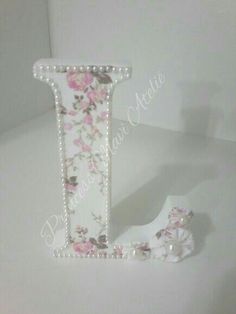 the letter j is decorated with flowers and pearls