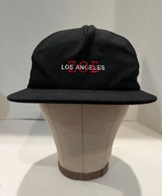 a hat that is on top of a mannequin's head with the word los angeles printed on it