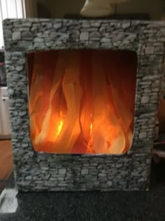 a stone fireplace with flames burning in it's front and side panels on the sides