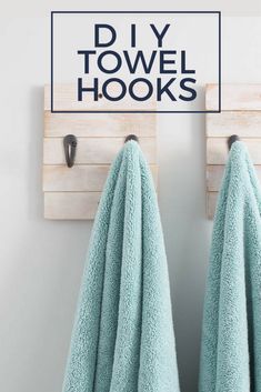 two towels hanging on hooks in front of a sign that says diy towel hooks