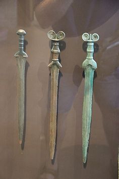 three different types of swords are on display