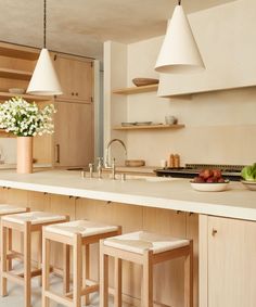 a kitchen filled with lots of counter top space next to a center island and wooden cabinets