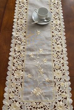 a table runner with coffee cup and saucer on it