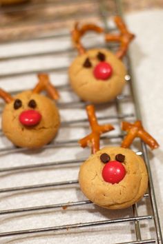 some cookies with reindeer noses are on a cooling rack