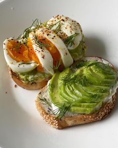 two pieces of bread with avocado and an egg on top