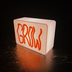 a white box with red writing on it sitting on top of a black countertop