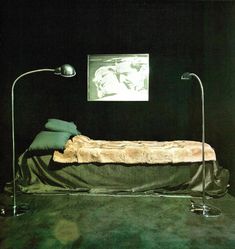 a bed sitting in the middle of a dark room