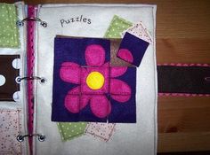 an open book with pink and purple flowers on it