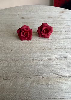 These have a deep red hue, perfect for the dark winter months, or any outfit that needs that extra color.  Rose Earrings are made by hand with polymer clay, they can be made your size preference, just leave a message in the notes when purchasing to leave your specific size preference.   Otherwise they are normally the size of a dime to a nickel, since they are handmade no two pairs will be exactly the same, just like real roses. If you want a certain color, message me and we can make you a custo Dark Winter, Rose Earrings, Deep Red, Red Roses, Polymer Clay, Etsy Earrings, Stud Earrings, Make It Yourself, Red