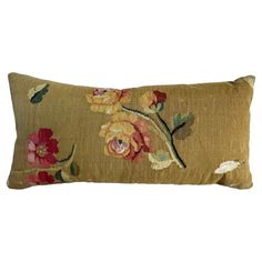 an embroidered pillow with flowers on it