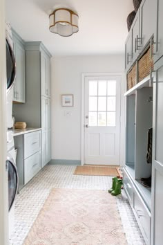 a clean and organized laundry room with washer and dryer in the foreground