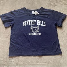 Navy Blue Crewneck Short Sleeve Beverly Hills California Badminton Club Crop Top T - Shirt With White Graphic New With Tags 18.5” Pit To Pit 19” Length Open To Offers! Blue Sporty Tops For Tennis, Sporty Blue Tennis Tops, Blue Short Sleeve Tennis Top, Blue Casual Tennis Top, Badminton Club, Beverly Hillbillies, Navy Blue Crewneck, Graphic Crop Top, Blue Crewneck