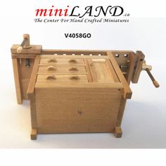 a wooden box with tools in it and the words mini land on top of it