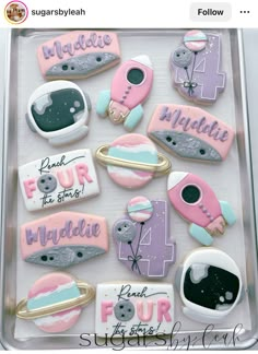 some decorated cookies in a plastic container with writing on them and magnets attached to it