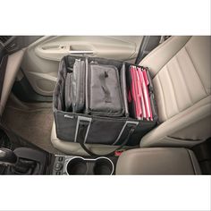 the interior of a car with several pieces of luggage in it