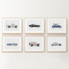 four framed photographs of cars are hanging on the wall in front of a white wall