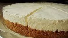 a cake with white frosting sitting on top of a table