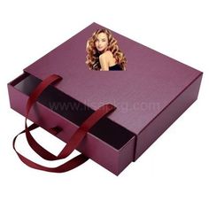 a purple box with a woman's face on the side and a red ribbon around it