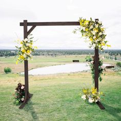 an outdoor ceremony setup with flowers and greenery