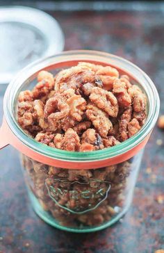 a glass jar filled with nuts on top of a table