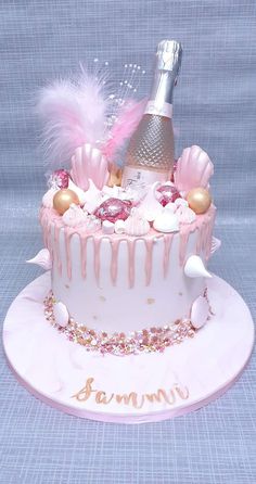 there is a cake with pink icing and decorations on the top that says champagne