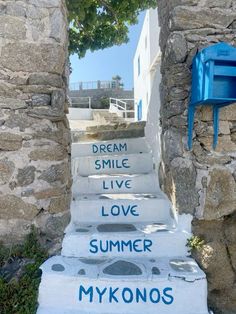 a set of steps that have been painted with words and phrases on them, along with a blue chair in the background